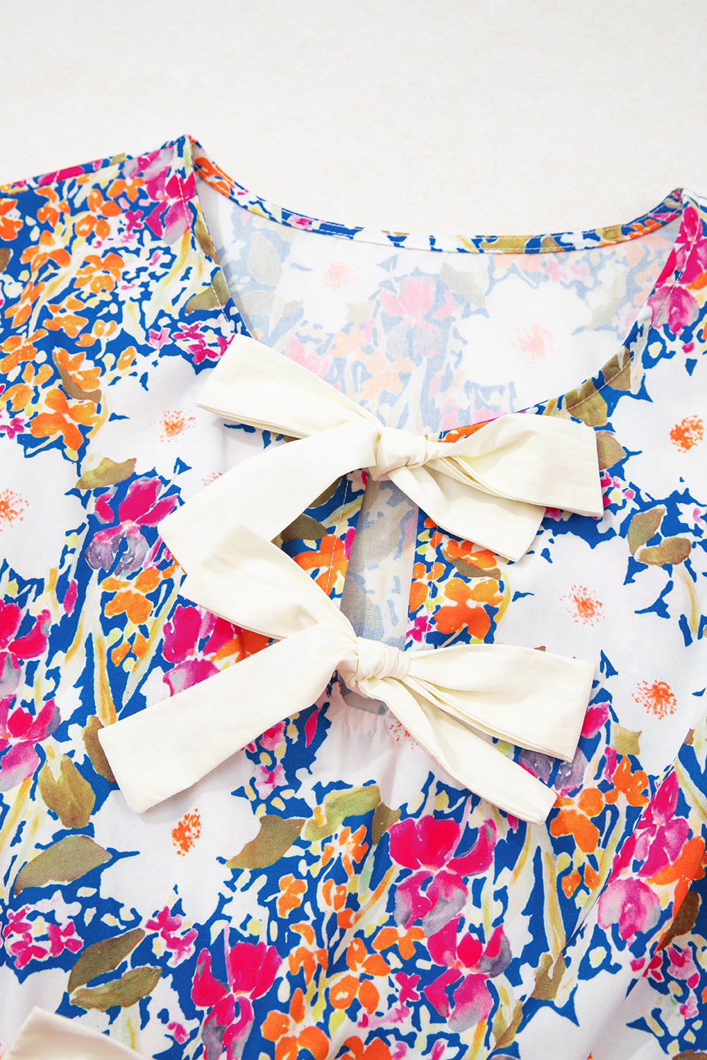Floral Print Bow Applique Slit Sleeveless Peplum Blouse